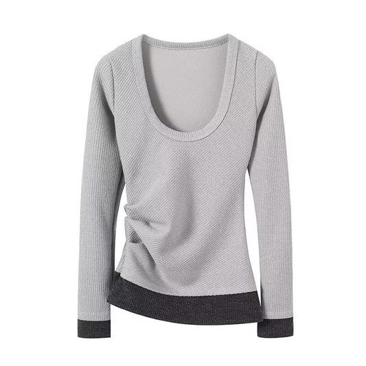 Woman wearing double layered pleated long sleeve top in a casual setting