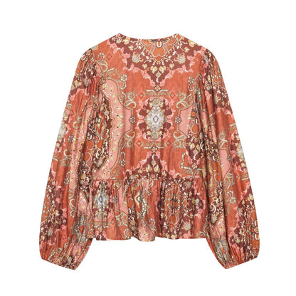 Woman wearing Retro Printed Long Sleeve Top with Skirt Hem in a bright cafe setting