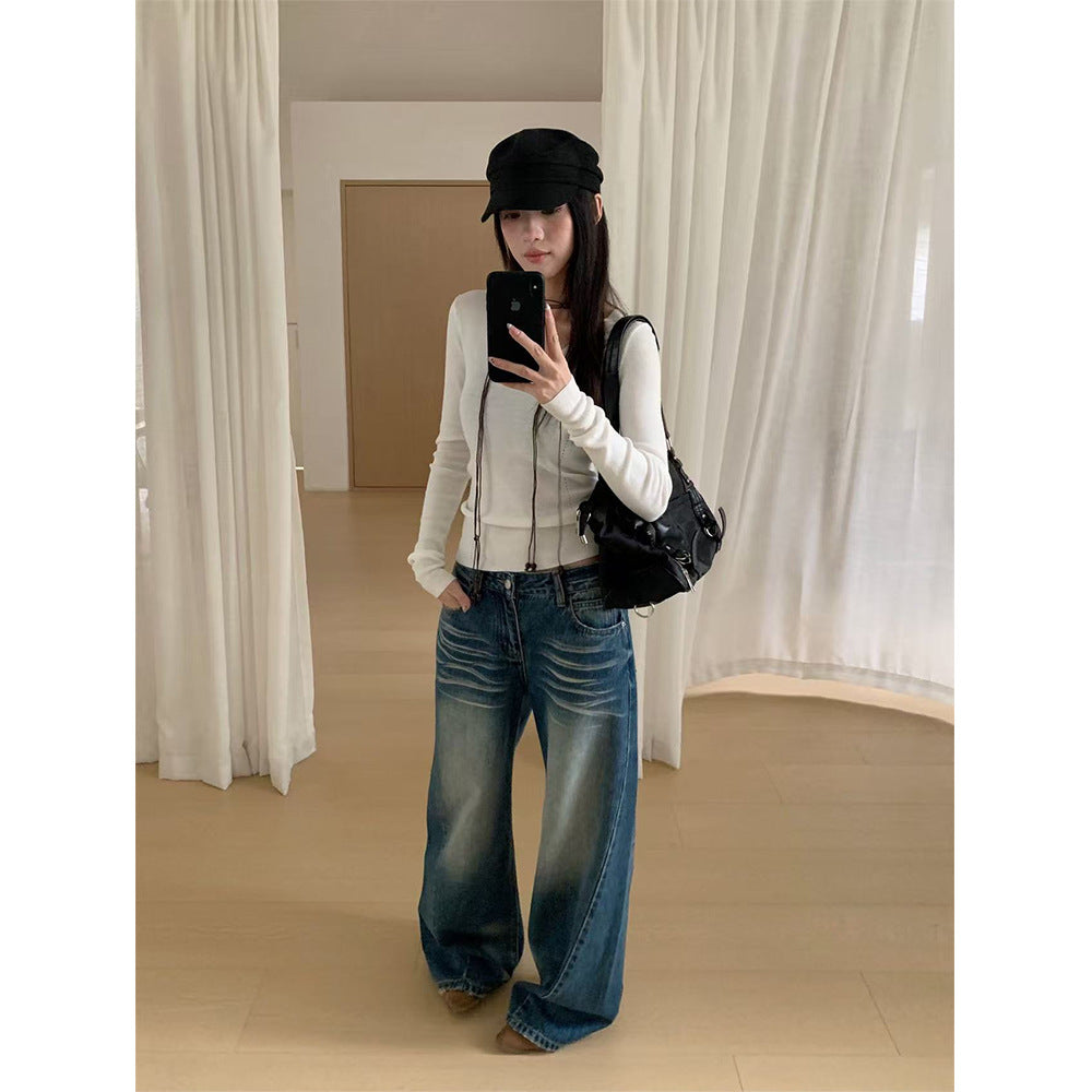Woman wearing Distressed Wide Leg Jeans in a casual setting