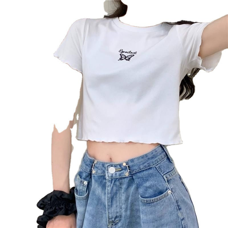 Woman wearing Butterfly Embroidered Crop Top in a sunny park
