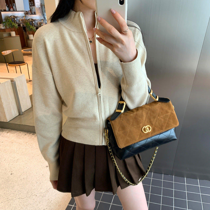 Woman wearing zippered long sleeve knit cardigan coat in urban setting
