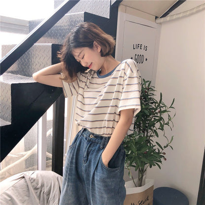 Woman wearing Academy Style Loose Fit Striped T-Shirt in a casual setting