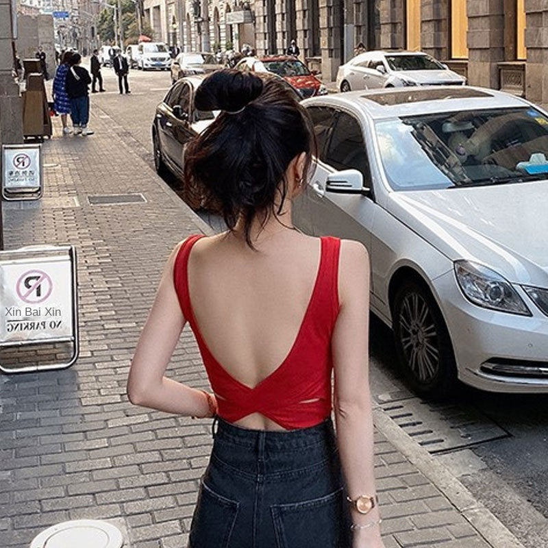 Woman wearing Cross Backless Camisole in a sunny outdoor setting
