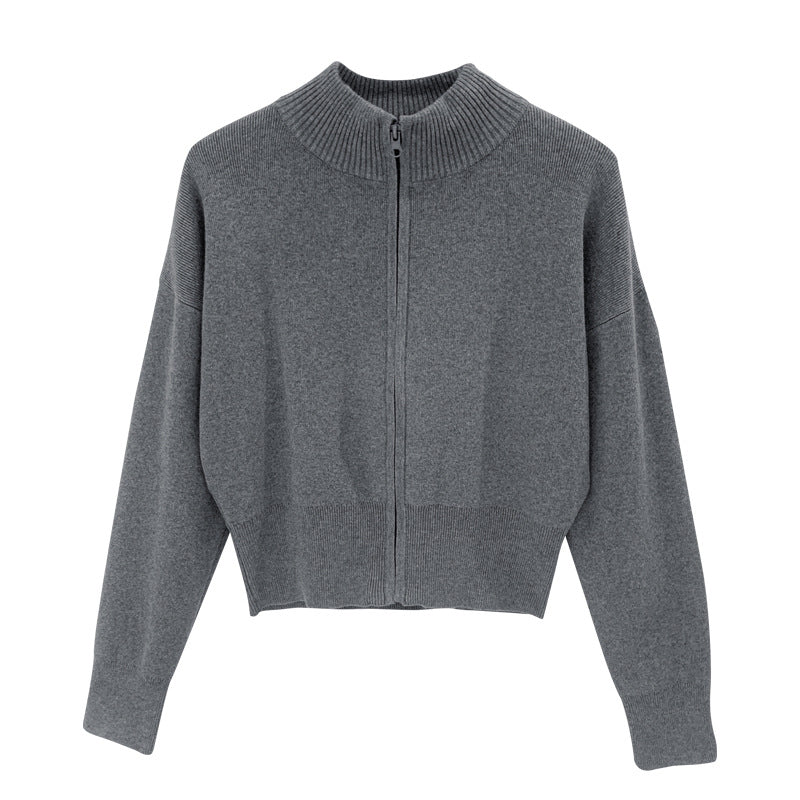 Woman wearing zippered long sleeve knit cardigan coat in urban setting