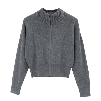 Woman wearing zippered long sleeve knit cardigan coat in urban setting