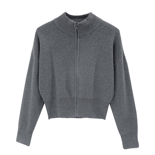 Woman wearing zippered long sleeve knit cardigan coat in urban setting