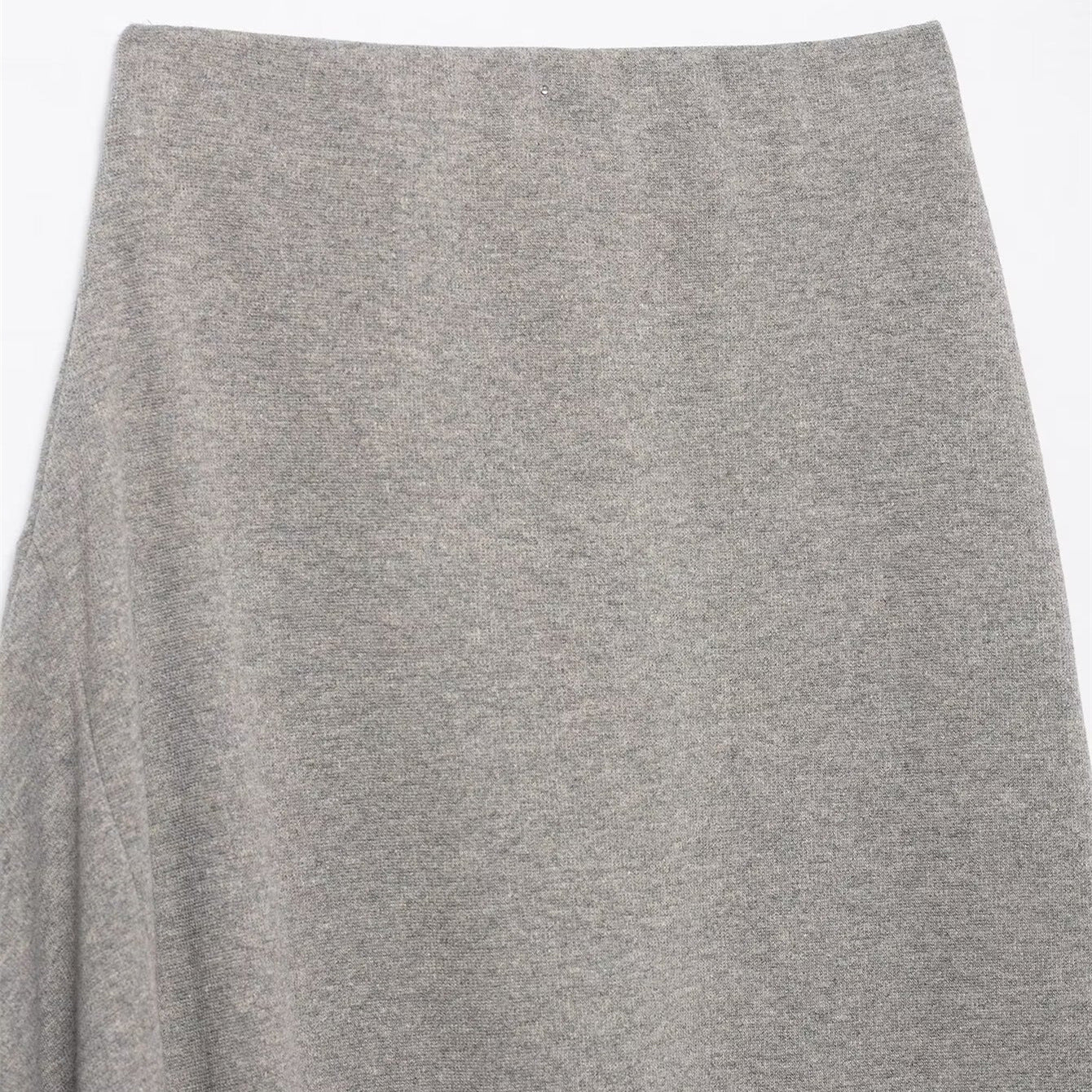 Woman wearing Asymmetric Pleated Midi Skirt in a stylish setting