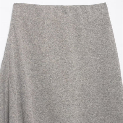 Woman wearing Asymmetric Pleated Midi Skirt in a stylish setting