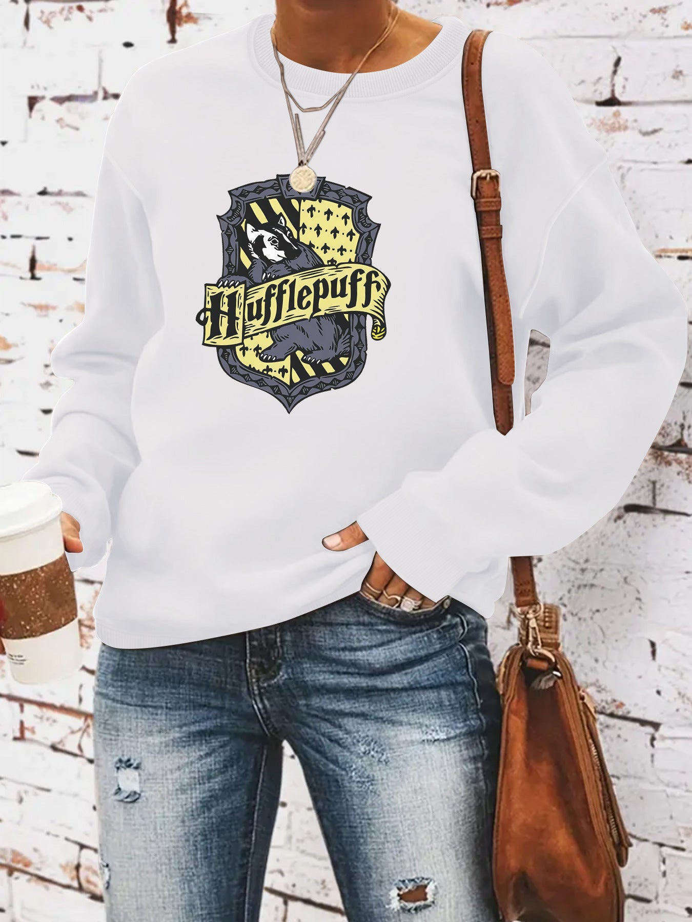 Woman wearing Hufflepuff hoodie in a casual setting