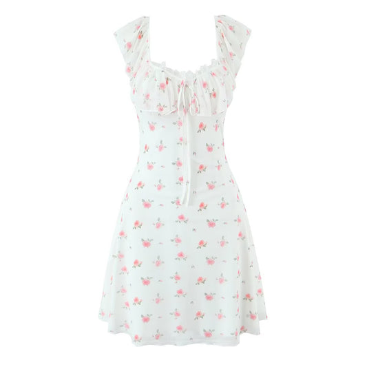Woman wearing Halter Neck Lace Tie Back Printed Dress in a summer setting