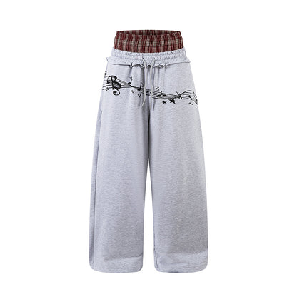 Woman wearing Double Waistband Music Note Graffiti Wide Leg Pants in a casual setting