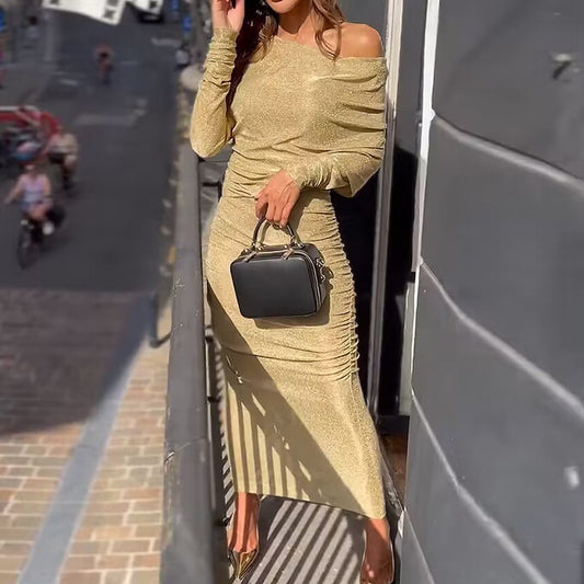 Woman wearing Gold One-Shoulder Bodycon Maxi Dress in an elegant setting