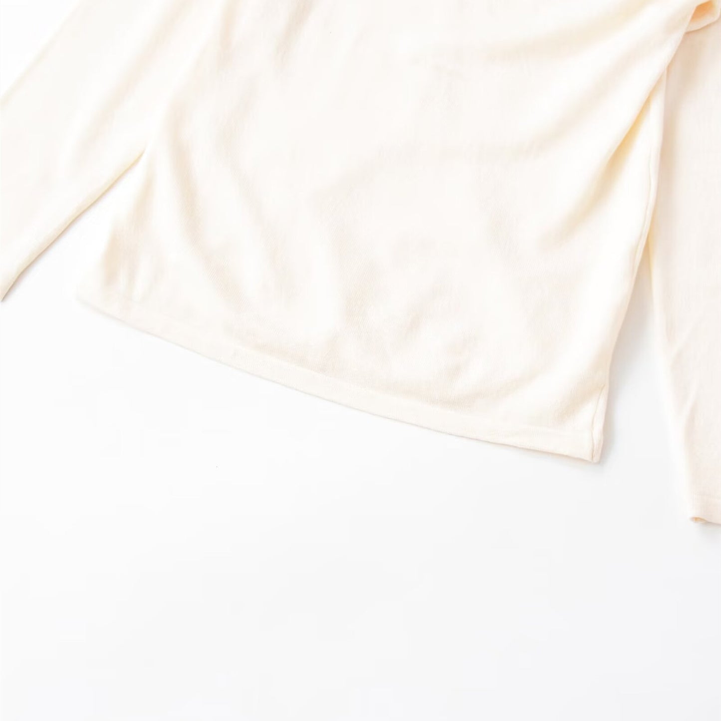 Woman wearing Irregular Pleated Long Sleeve Top in a casual setting