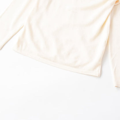Woman wearing Irregular Pleated Long Sleeve Top in a casual setting