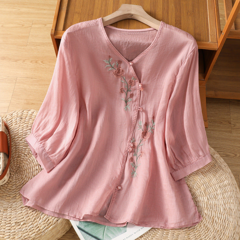 Woman wearing embroidered shirt top in a casual outdoor setting