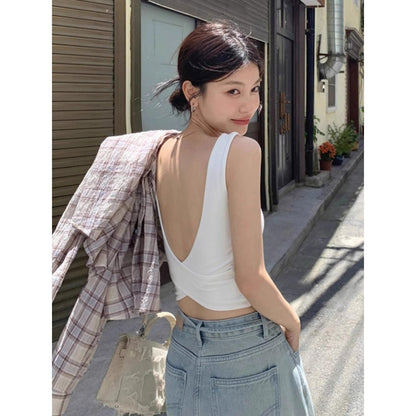 Woman wearing Cross Backless Camisole in a sunny outdoor setting