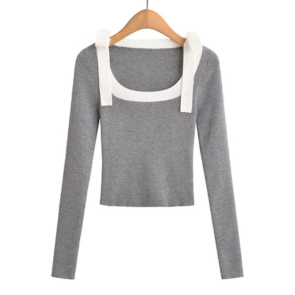 Woman wearing Square Neck Bow Ribbon Slim Fit Long Sleeve Sweater in a chic urban setting