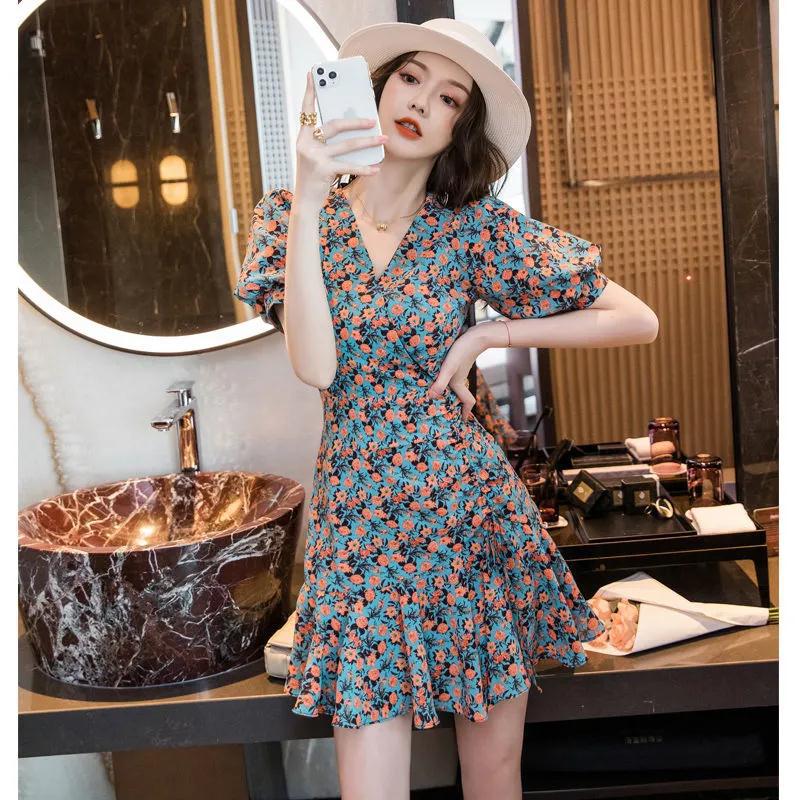 Woman wearing Floral Print A-Line Dress in a garden setting