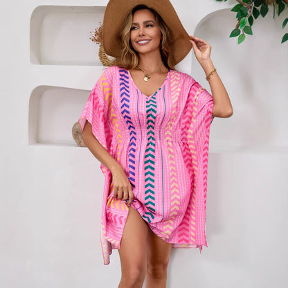 Woman wearing Bohemian Floral V-Neck Mini Dress in a sunny beach setting
