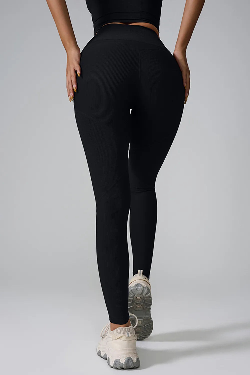 Woman wearing High Waist Active Leggings in a gym setting