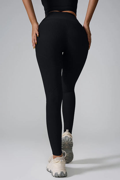 Woman wearing High Waist Active Leggings in a gym setting