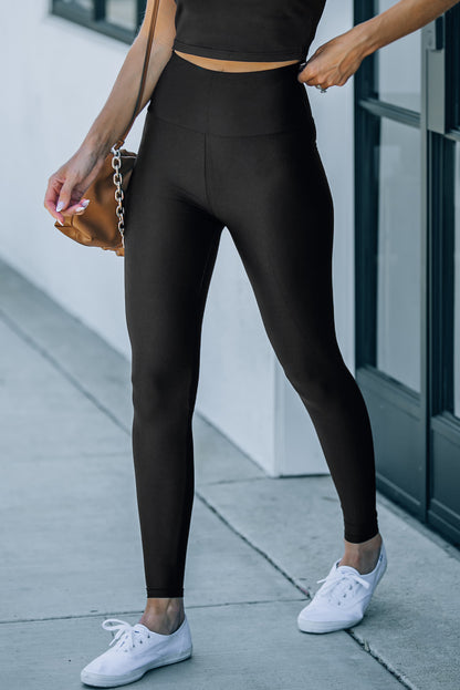 Woman wearing Black High Rise Tight Leggings in a casual setting
