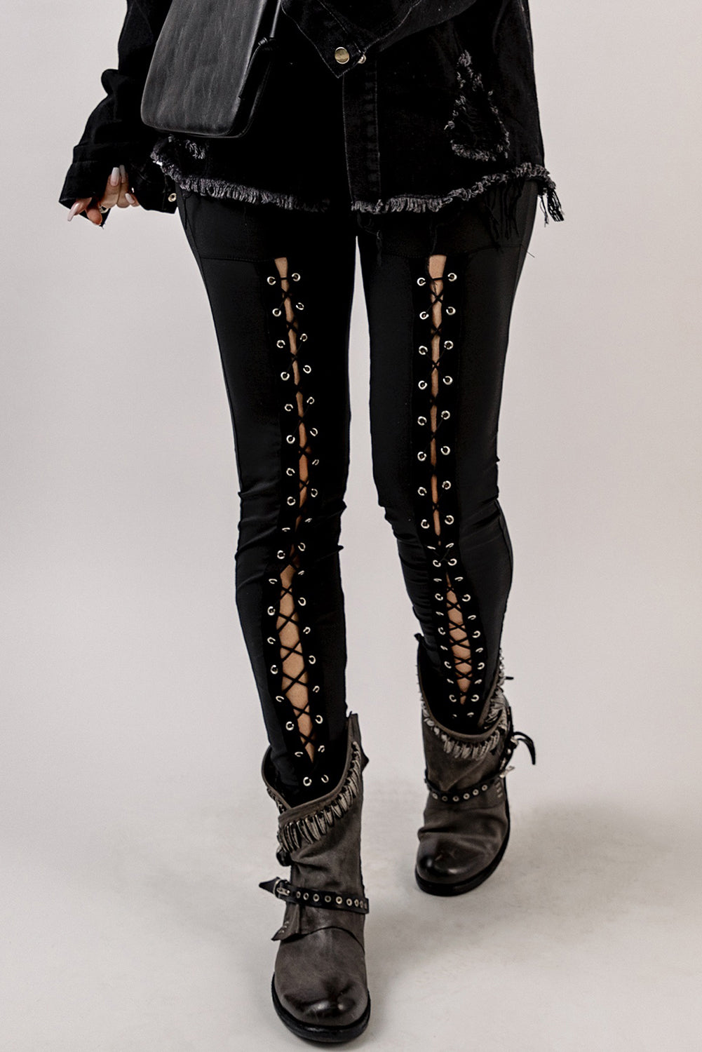 Woman wearing Black Grommet Lace Up Front Leggings in a stylish setting
