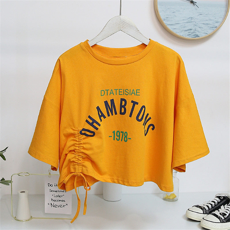 Woman wearing Chic Drawstring Cropped Top in a casual setting