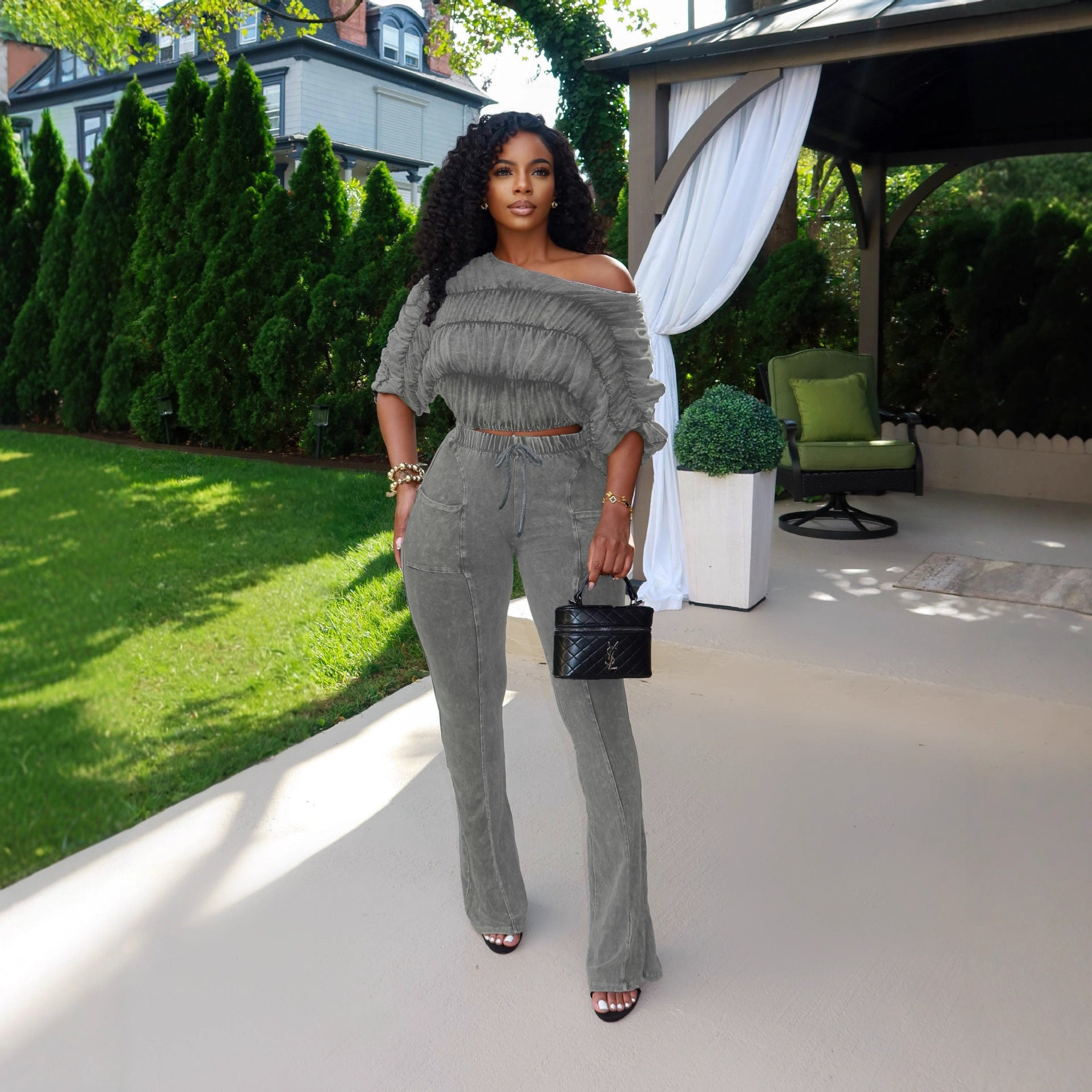 Woman wearing Flattering Two Piece Set with Crop Top and Flared Pants in a stylish urban setting