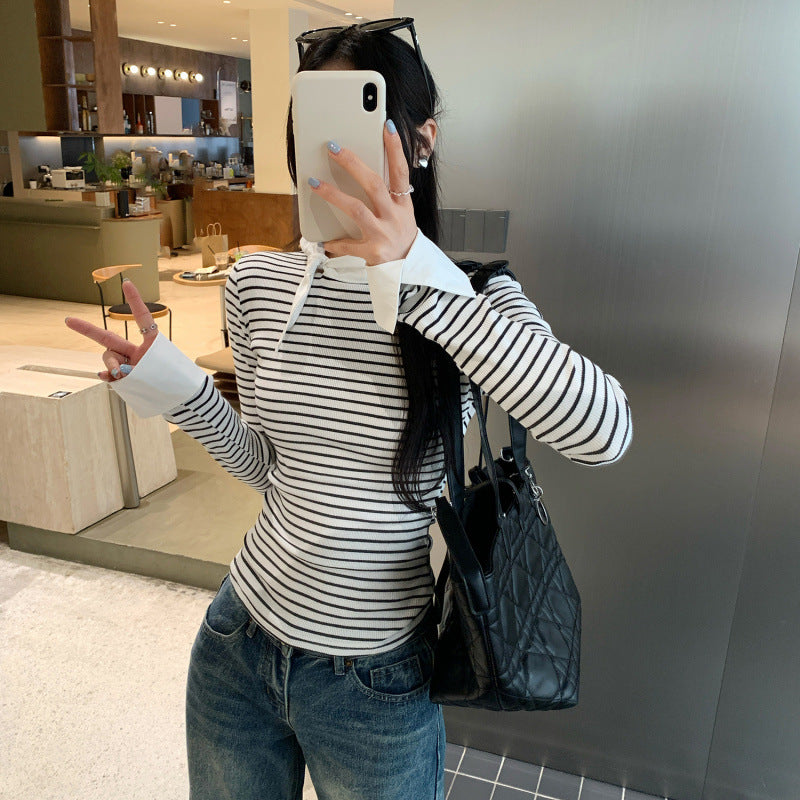 Woman wearing Women's Stripe Mock Neck Tie-Front Top in a stylish setting