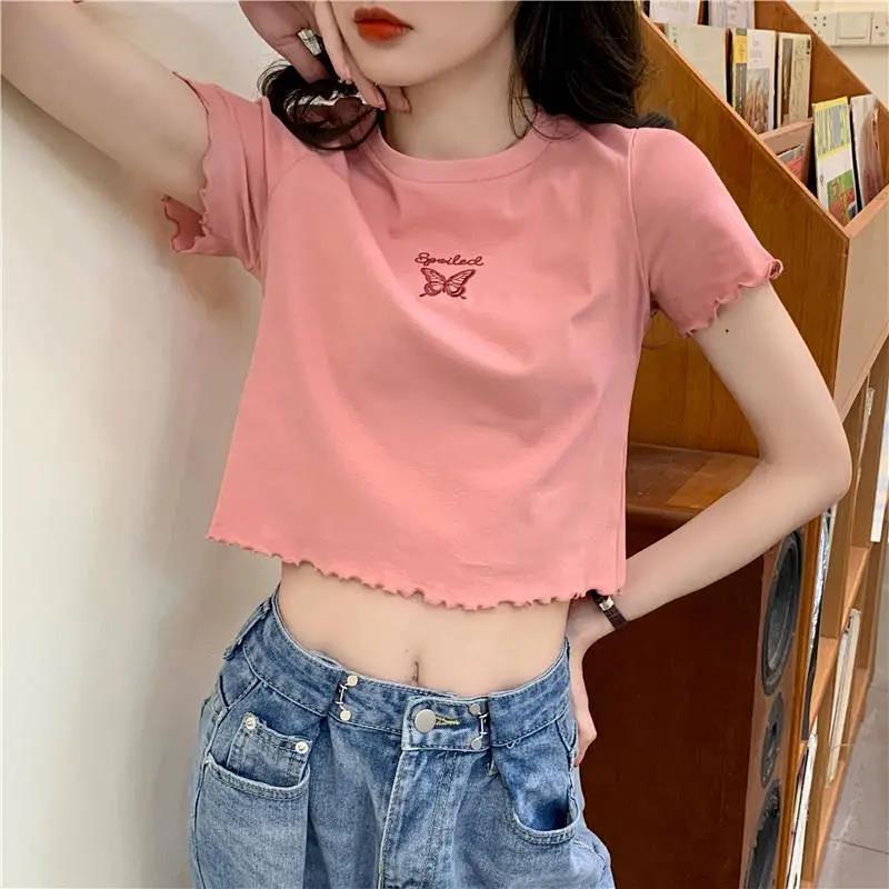 Woman wearing Butterfly Embroidered Crop Top in a sunny park