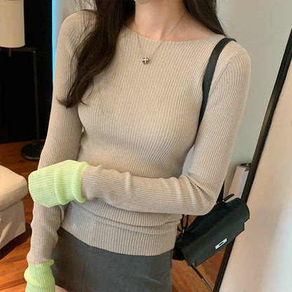 Woman wearing Colour Block Slim Fit Knit Sweater in a stylish urban setting