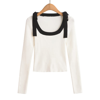 Woman wearing Square Neck Bow Ribbon Slim Fit Long Sleeve Sweater in a chic urban setting