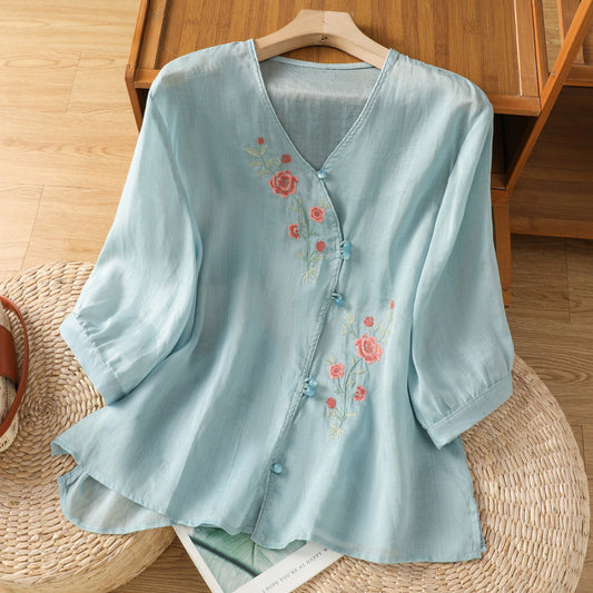 Woman wearing embroidered shirt top in a casual outdoor setting