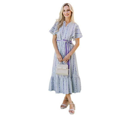 Woman wearing Bohemian Floral Ruffle Maxi Dress in a garden