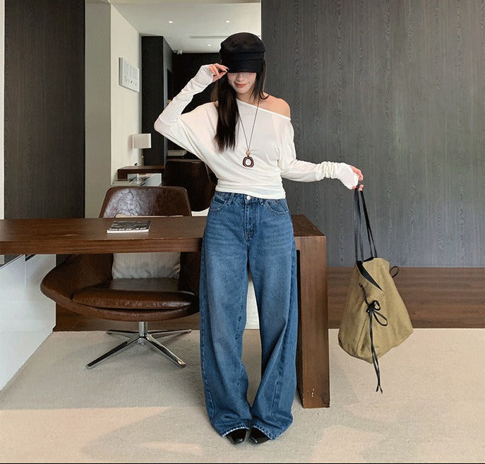 Woman wearing Distressed Wide Leg Jeans in a casual street setting