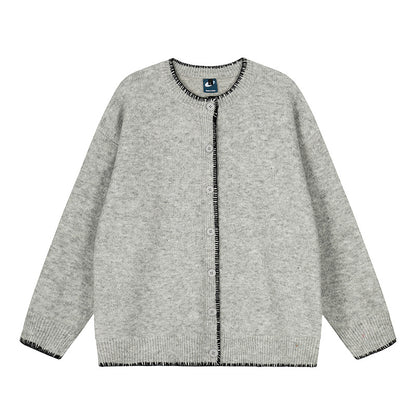 Woman wearing Hand-Stitched Loose Fit Knit Cardigan in a cozy setting
