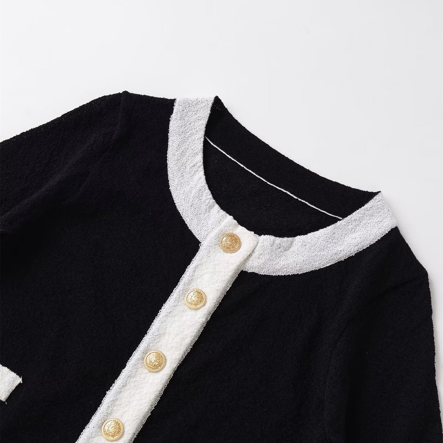 Woman wearing tailored contrasting knitted sweater in a cozy setting