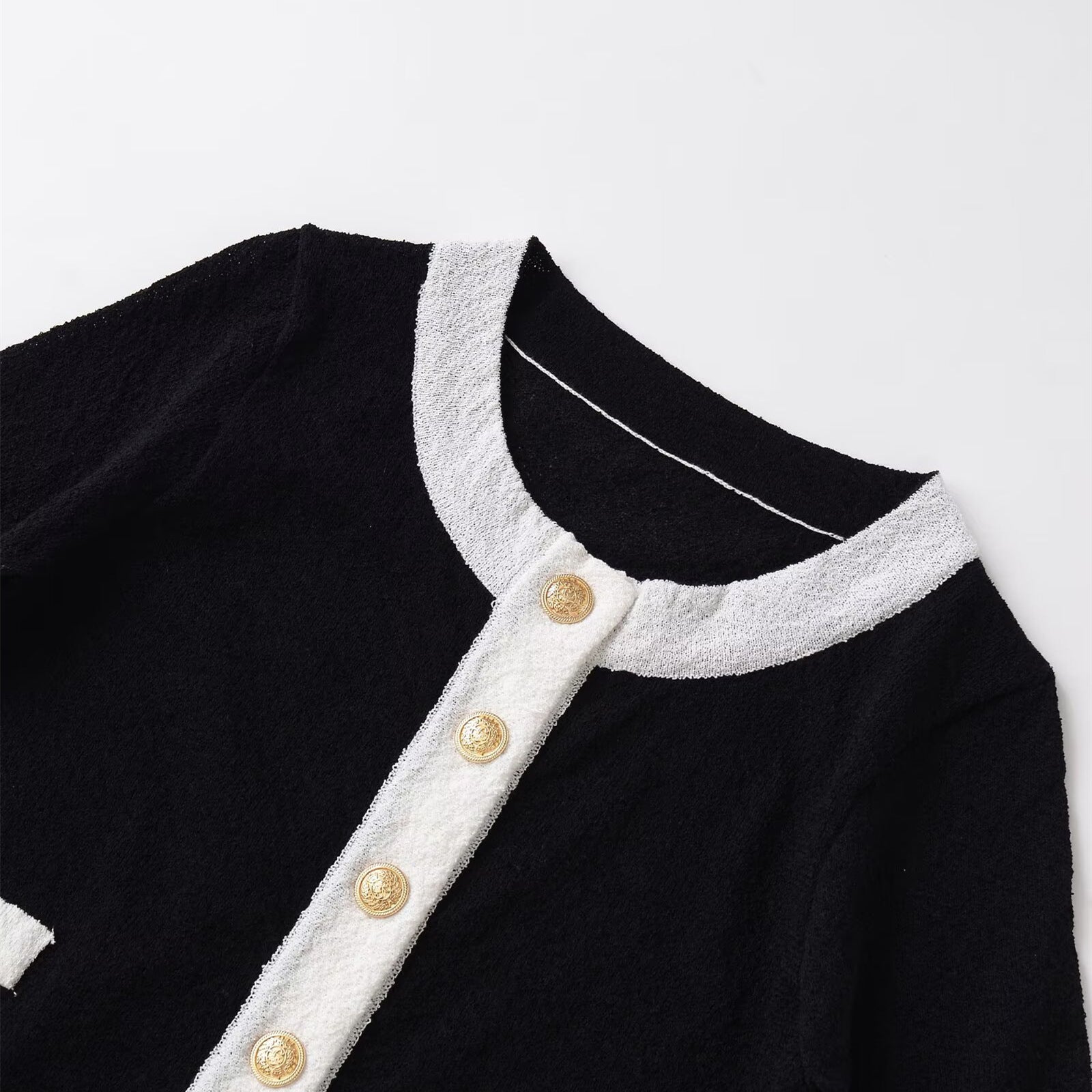 Woman wearing tailored contrasting knitted sweater in a cozy setting