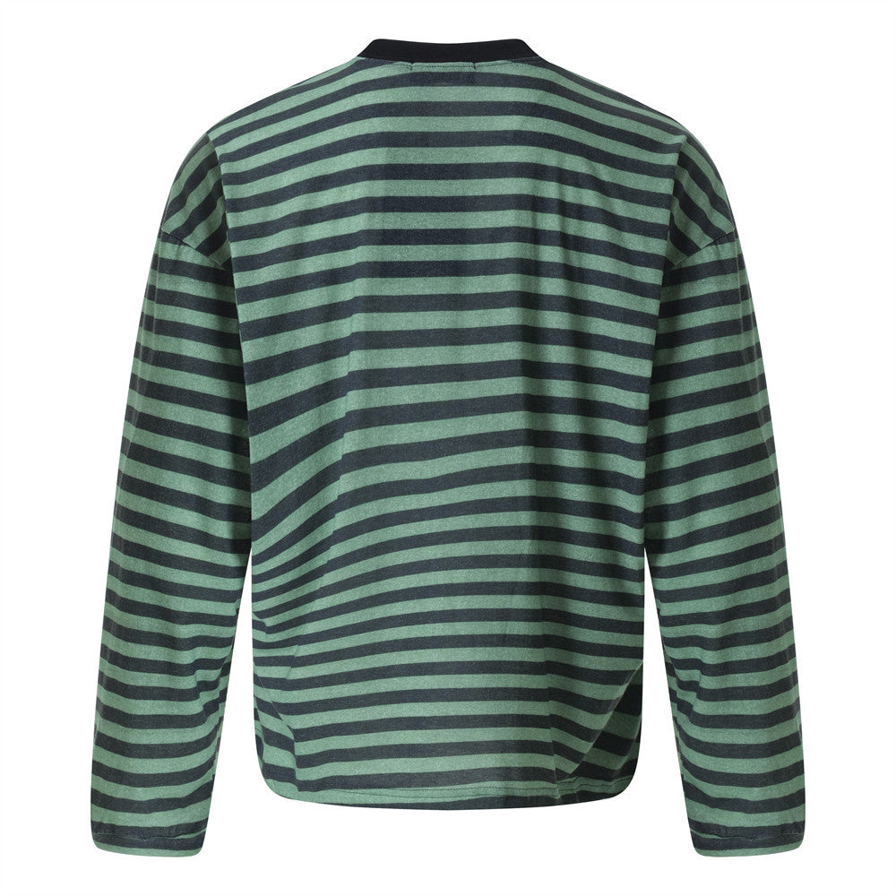 Woman wearing Loose Striped Round Neck Shirt in casual setting