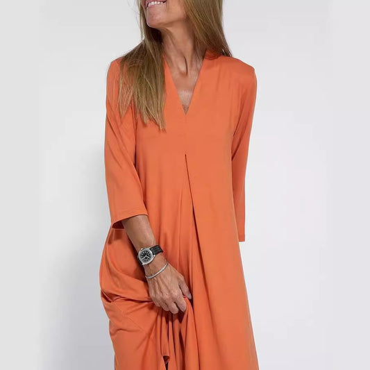 Woman wearing V Neck Three Quarter Sleeve Knit Dress in a stylish urban setting