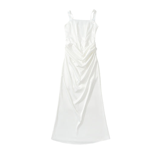 Woman wearing backless camisole dress in a summer setting