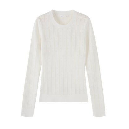 Woman wearing Hollow-Out Round Neck Long Sleeve Knit Top in a stylish setting
