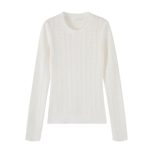 Woman wearing Hollow-Out Round Neck Long Sleeve Knit Top in a stylish setting