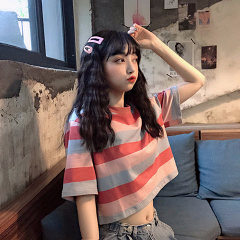 Woman wearing Loose Rainbow Striped Crop Top in a sunny park
