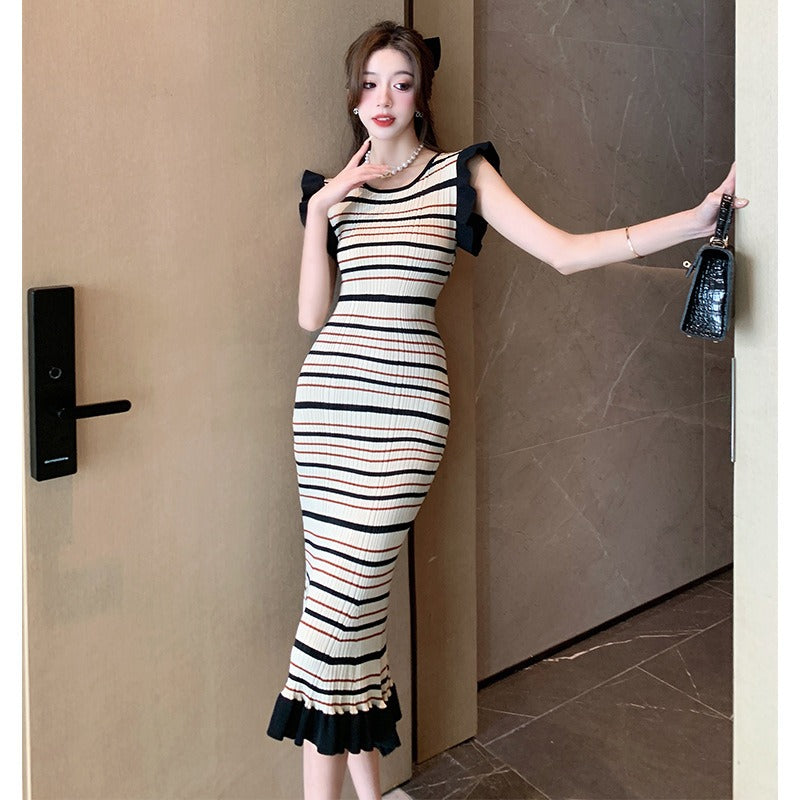 Woman wearing Women’s Striped Knitwear Dress in a sunny outdoor setting