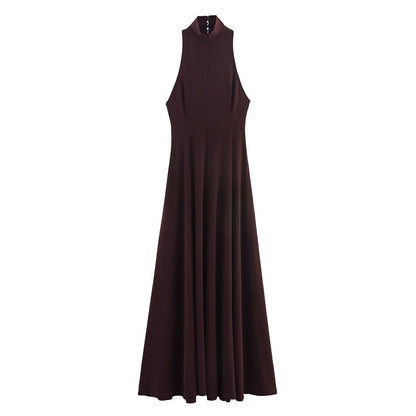 Woman wearing backless long dress in a sunny outdoor setting