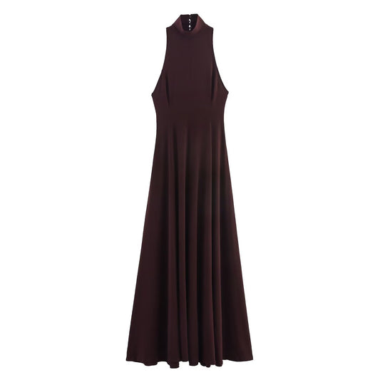 Woman wearing backless long dress in a sunny outdoor setting