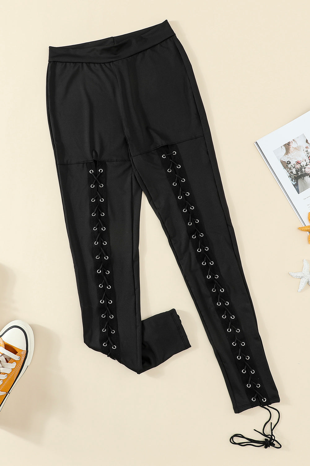 Woman wearing Black Grommet Lace Up Front Leggings in a stylish setting