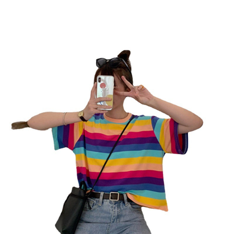 Woman wearing Rainbow Stripe Loose T Shirt in a sunny outdoor setting
